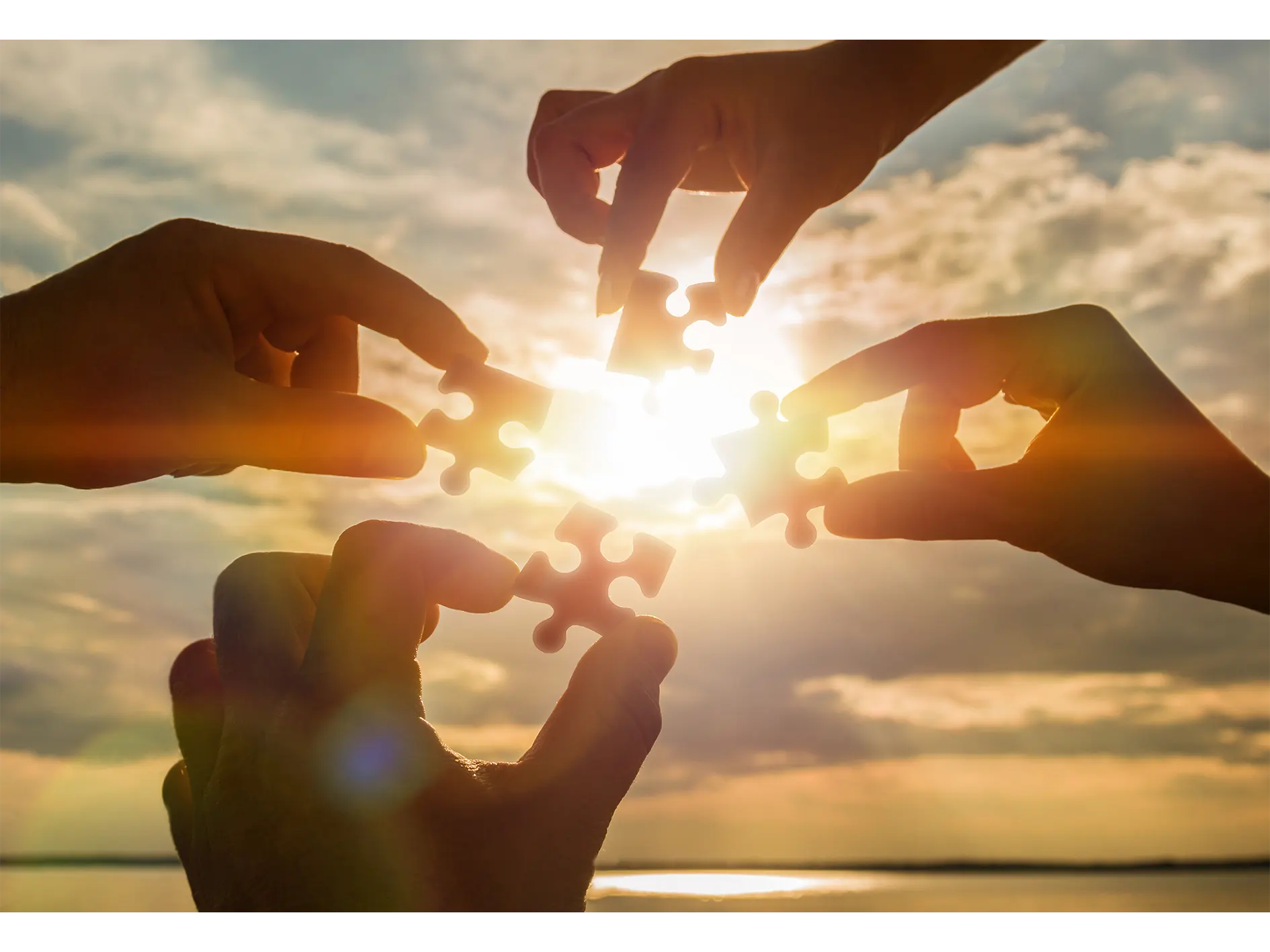 Hands holding puzzle pieces